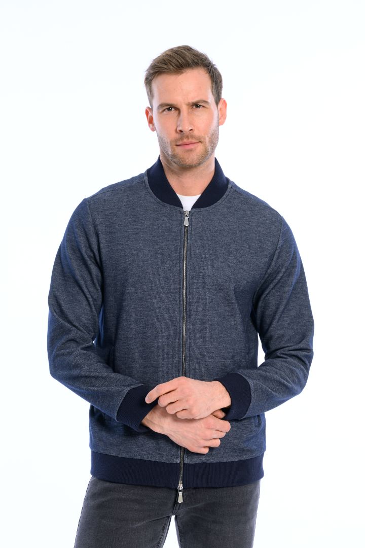 Man wearing a blue zip-up sweatshirt on a white background