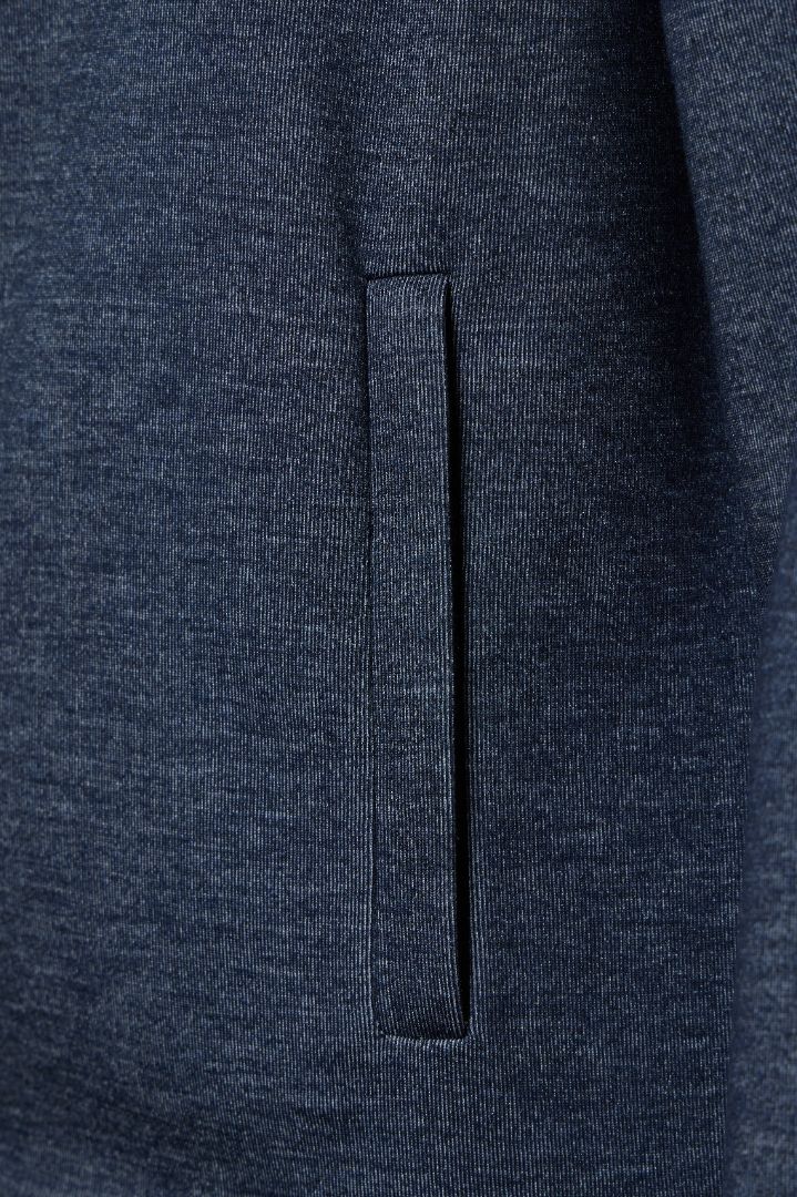 Close-up of a dark blue fabric with a pocket detail