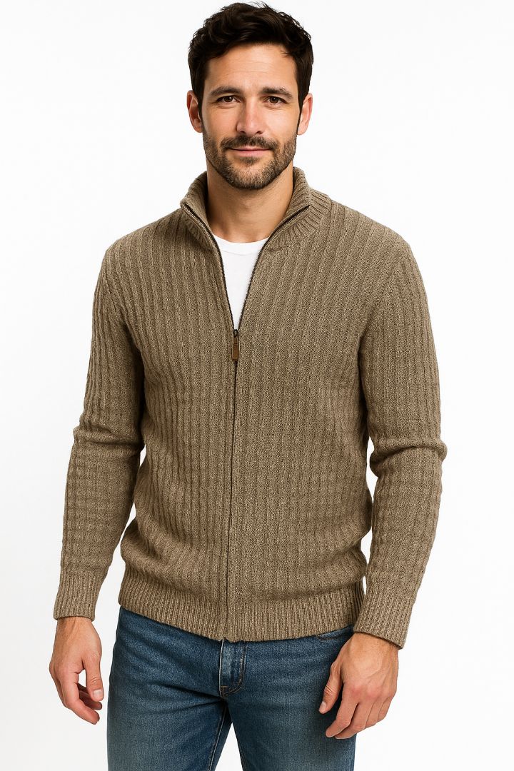 Man wearing a brown zip-up sweater and blue jeans on a white background