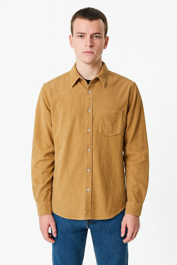 Man wearing a brown button-up shirt and blue jeans on a white background