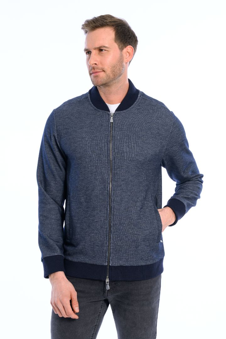 Man wearing a blue zip-up sweater on a white background